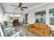 Relaxing sunroom with rocking chairs, a couch, and lots of windows at 16 Captains Pt, Fruitland Park, FL 34731