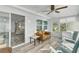 Sunroom with rocking chairs, a couch, and access to the outdoors at 16 Captains Pt, Fruitland Park, FL 34731