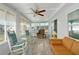 Sunroom with rocking chairs, a couch, and large windows at 16 Captains Pt, Fruitland Park, FL 34731