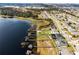 Aerial view of waterfront homes, lush landscaping, private docks, and community amenities in a desirable lakeside neighborhood at 16428 Good Hearth Blvd, Clermont, FL 34711