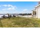 Sprawling backyard with a clear view of the lake, featuring a pool, dock, and lush green lawn at 16428 Good Hearth Blvd, Clermont, FL 34711
