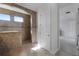 Bright bathroom featuring a tiled shower with a built-in bench and tiled floor, accented by natural light at 16428 Good Hearth Blvd, Clermont, FL 34711