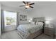 Comfortable bedroom with ceiling fan and large window at 16428 Good Hearth Blvd, Clermont, FL 34711