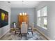 Formal dining room with wooden table, chairs, and an art piece at 16428 Good Hearth Blvd, Clermont, FL 34711