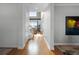 Bright entryway with hardwood floors and a view of the living room and lake at 16428 Good Hearth Blvd, Clermont, FL 34711