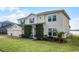 Two-story house with a three-car garage, waterfront view, and manicured lawn at 16428 Good Hearth Blvd, Clermont, FL 34711