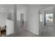Hallway features carpet, neutral paint, and doors leading to bedrooms and bathrooms at 16428 Good Hearth Blvd, Clermont, FL 34711
