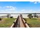 Long wooden walkway leads to private lake access at 16428 Good Hearth Blvd, Clermont, FL 34711