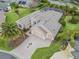 Single-Gathering house with three-car garage, palm trees, and spacious yard at 1644 Shell Point Ave, The Villages, FL 32162