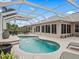 Relaxing pool and patio area with screened enclosure and lush landscaping at 1644 Shell Point Ave, The Villages, FL 32162