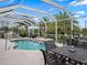 Inviting pool area with covered patio and seating at 1644 Shell Point Ave, The Villages, FL 32162