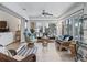 Relaxing sunroom featuring wicker seating and large windows offering ample natural light at 1644 Shell Point Ave, The Villages, FL 32162