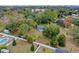 Aerial view showing home's location on a large lot with mature trees at 1660 1St St, Clermont, FL 34711