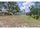 Large backyard featuring mature trees and a partial fence at 1660 1St St, Clermont, FL 34711