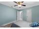 Bright bedroom with light blue walls and ceiling fan at 1660 1St St, Clermont, FL 34711
