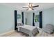 Cozy bedroom with light blue walls and a gray bed at 1660 1St St, Clermont, FL 34711