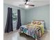 Bedroom with ceiling fan and colorful patchwork quilt at 1660 1St St, Clermont, FL 34711