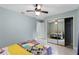 Bedroom with mirrored closet and ceiling fan at 1660 1St St, Clermont, FL 34711
