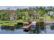 Private dock with covered seating area and boat slip on a tranquil waterway at 1660 1St St, Clermont, FL 34711