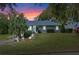 Charming house with a gray exterior, landscaping, and a walkway leading to the entrance at 1660 1St St, Clermont, FL 34711