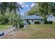 Single-story home with a landscaped yard and a blue roof at 1660 1St St, Clermont, FL 34711