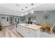 Open kitchen with island, white cabinets, granite countertops and stainless steel appliances at 1660 1St St, Clermont, FL 34711