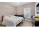 Bright bedroom with a queen-size bed and window at 188 Williamson Dr, Davenport, FL 33897