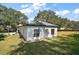 Side view of the house showcasing the exterior and yard at 19211 County Road 455, Clermont, FL 34715