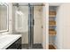 Bathroom with walk-in shower, stone tile, and shelving at 2001 Sanford Ave, Sanford, FL 32771