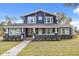 Renovated two-story home with a welcoming front porch and well-manicured lawn at 2001 Sanford Ave, Sanford, FL 32771