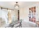 Bright home office features glass desk, chandelier, and French doors at 2001 Sanford Ave, Sanford, FL 32771