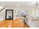 Elegant living room with hardwood floors, a large mirror, and views to the dining area at 2001 Sanford Ave, Sanford, FL 32771