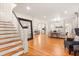 Open living area featuring hardwood floors, a grand mirror, and stylish furniture at 2001 Sanford Ave, Sanford, FL 32771