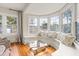 Sunroom with built-in window seat and hardwood floors at 2001 Sanford Ave, Sanford, FL 32771