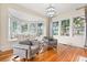 Sunroom with built-in window seat and hardwood floors at 2001 Sanford Ave, Sanford, FL 32771