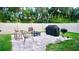 Inviting backyard patio with outdoor seating, fire pit, and grilling area perfect for entertaining at 2295 Delhi Pl, Sanford, FL 32771