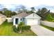 Well maintained single story home with tidy landscaping, an attached two-car garage, and a paved driveway at 2295 Delhi Pl, Sanford, FL 32771