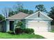 Charming single-story home showcasing its well-maintained lawn and attached two-car garage at 2295 Delhi Pl, Sanford, FL 32771
