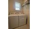 Functional laundry area with side-by-side washer and dryer, plus overhead storage at 2295 Delhi Pl, Sanford, FL 32771