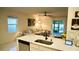 Living room with sectional sofa and view of the kitchen and back patio at 2295 Delhi Pl, Sanford, FL 32771