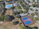 Aerial view showing tennis courts and pool at 25141 Clifford Hl, Leesburg, FL 34748
