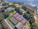 Aerial view of community with tennis courts and pool at 25141 Clifford Hl, Leesburg, FL 34748