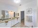 Updated bathroom with double vanity, granite countertops, and a walk-in shower at 25141 Clifford Hl, Leesburg, FL 34748