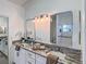 Modern bathroom boasts double sinks, granite countertops, and updated fixtures at 25141 Clifford Hl, Leesburg, FL 34748