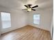 Bright bedroom with ceiling fan and light flooring at 25141 Clifford Hl, Leesburg, FL 34748