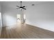 Spacious bedroom with hardwood floors and ceiling fan at 25141 Clifford Hl, Leesburg, FL 34748