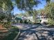 Community clubhouse with landscaping and a paved driveway at 25141 Clifford Hl, Leesburg, FL 34748