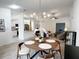 Modern dining room with a round table, chandelier, and hardwood floors at 25141 Clifford Hl, Leesburg, FL 34748
