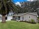 Newly renovated home with a landscaped yard and palm trees at 25141 Clifford Hl, Leesburg, FL 34748