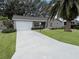 House exterior with driveway and landscaping at 25141 Clifford Hl, Leesburg, FL 34748